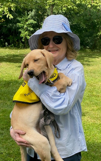 Mary Crocker holds CNIB Guide Dog puppy, Amber.