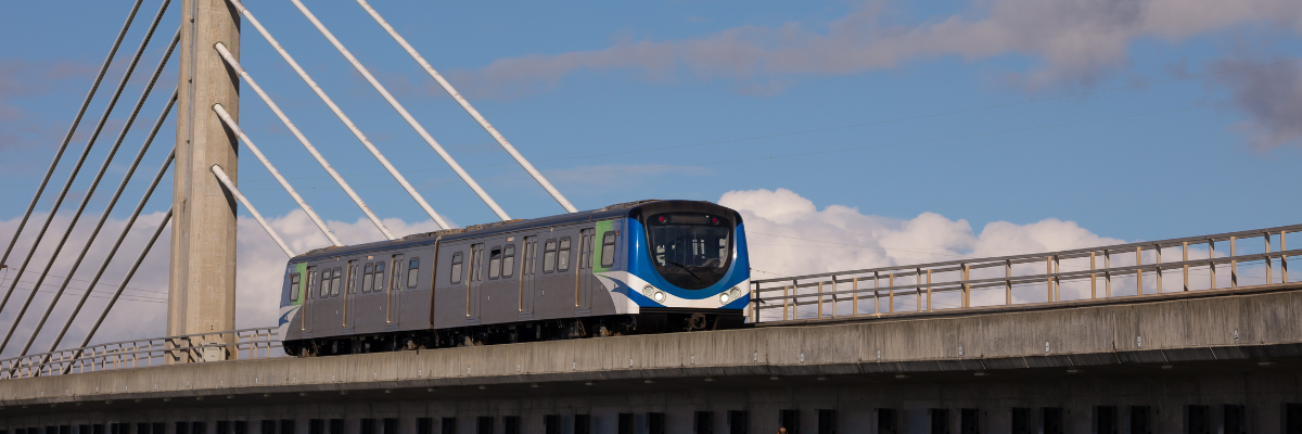 A Skytrain passing across a bridge in the blue Vancouver sky.