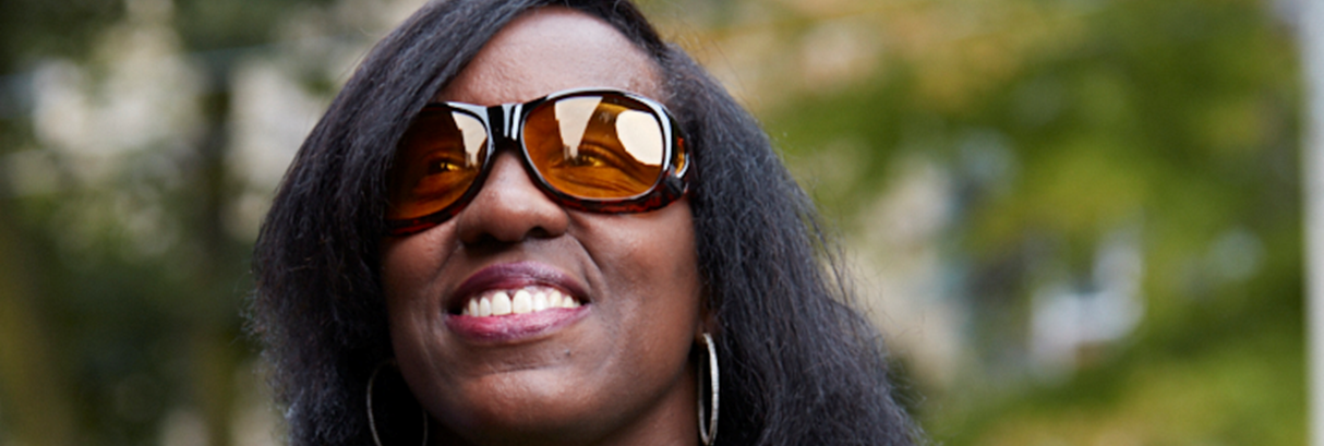 A woman in glasses, smiling   