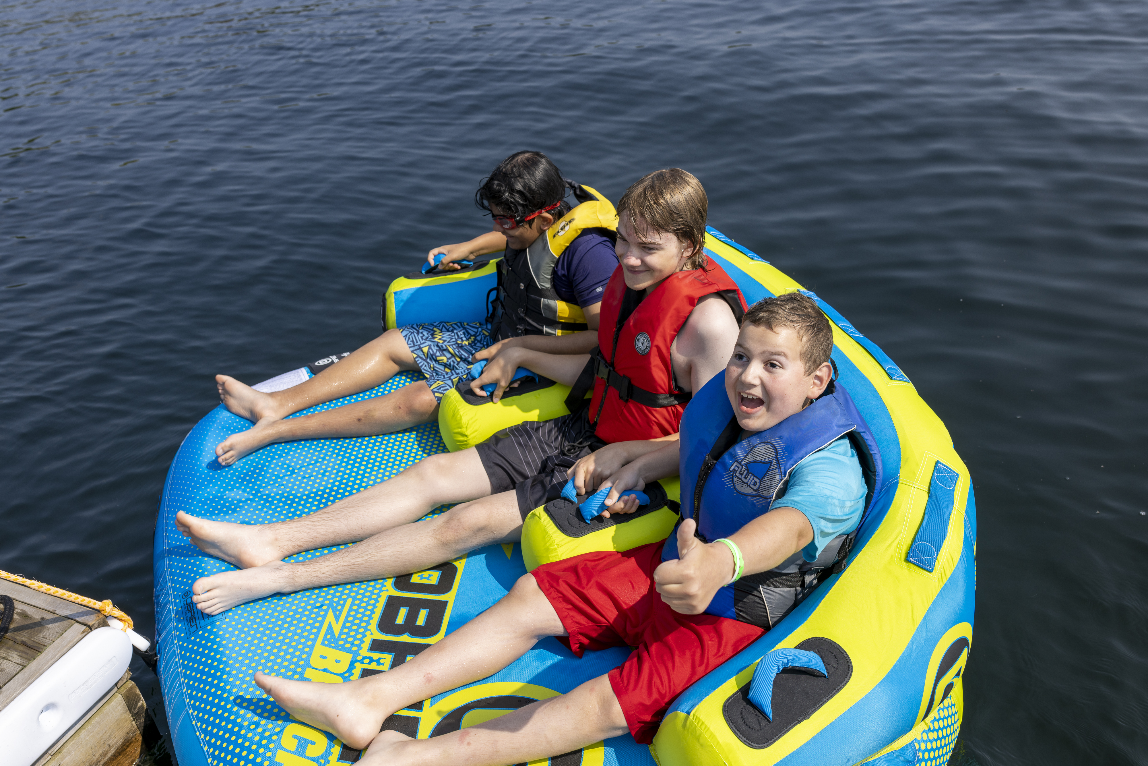 Modern photo of children in a large floatie on Lake Joe 