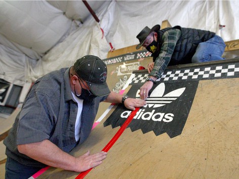 Volunteers place bright coloured tape on the ramps The Compound skatepark in Ramsay, AB. 