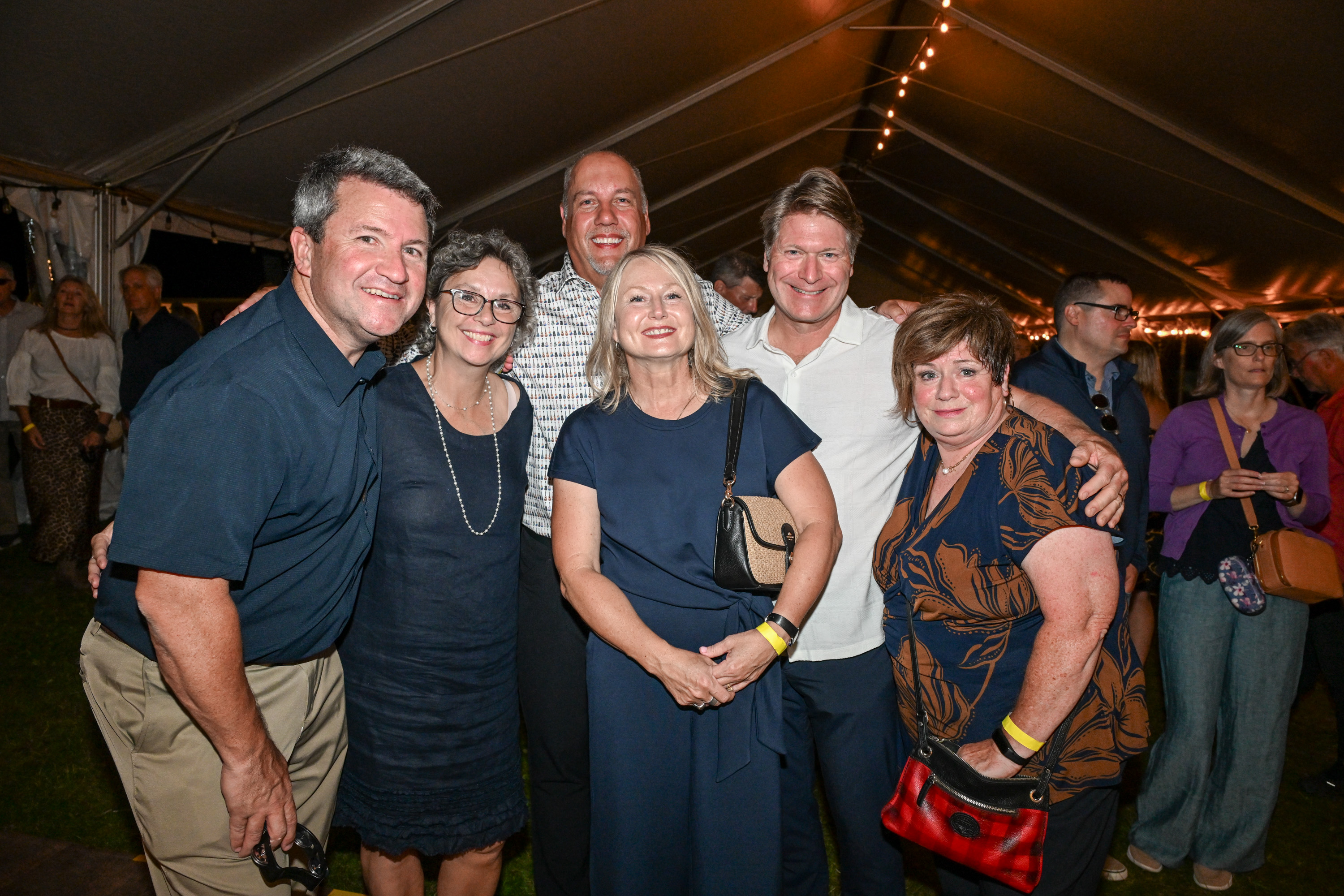 Several people smiling and posting for a photo