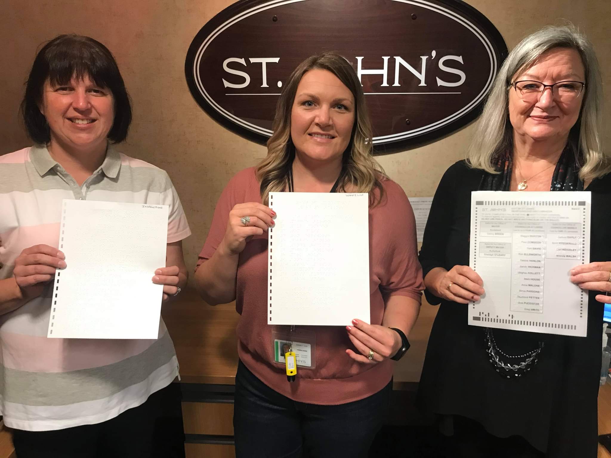 Kim Hart CNIB, Trisha Rose, City of St John’s Elections Coordinator and Debbie Ryan, CNIB, holding the first braille ballot being used in the municipal 2021 election.