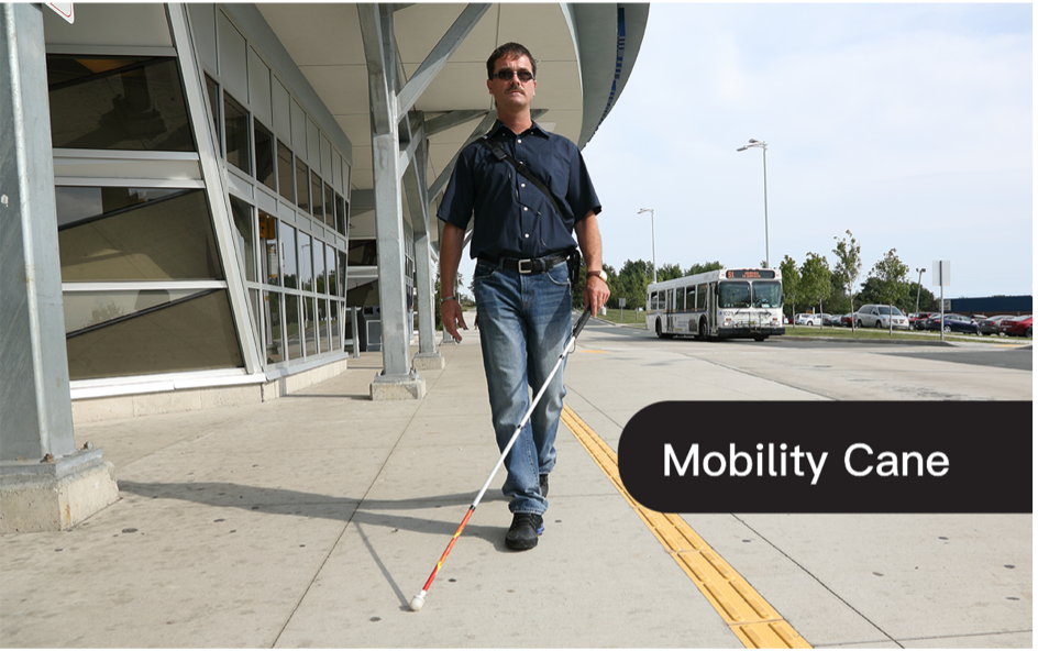 A man using a mobility cane outdoors to navigate alongside a building on a sunny day. The Text "Mobility Cane" are overlayed in white text on a black background.