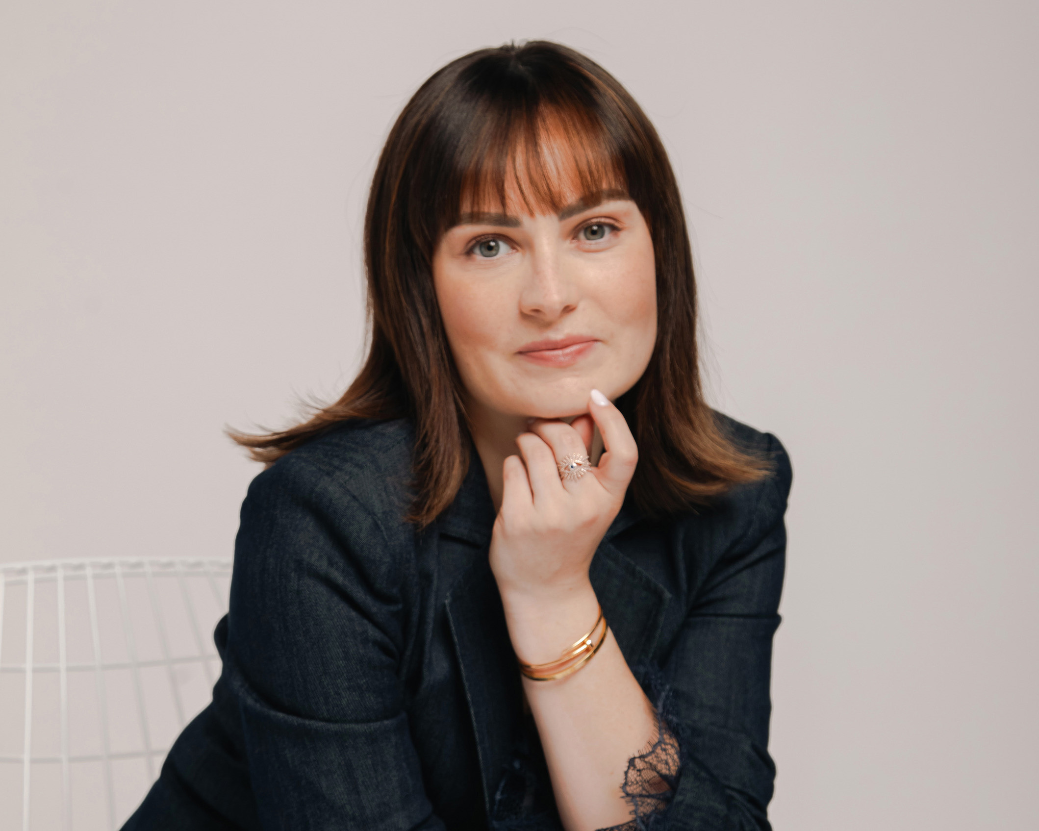Headshot of Molly Burke sitting on a chair
