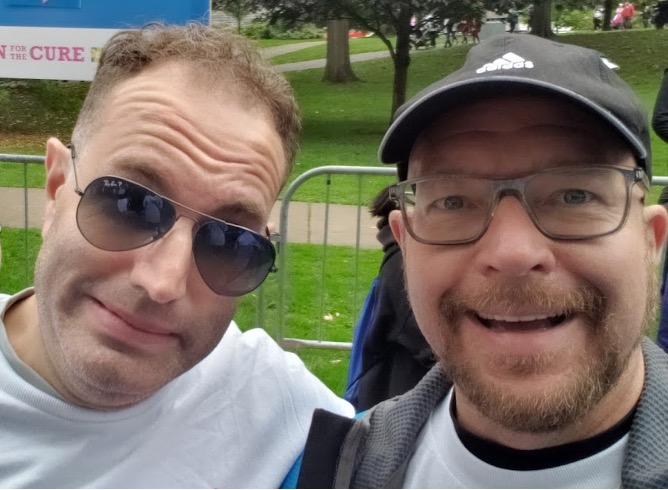 Jason Mitschele and Dwayne King are standing together at a CIBC Run for the Cure event.