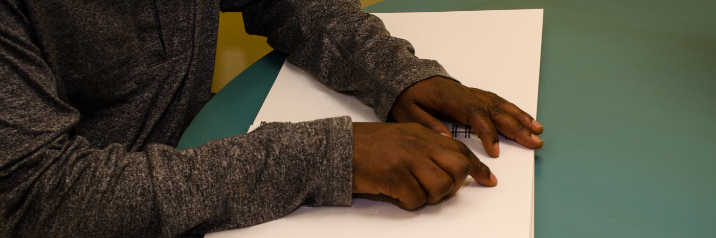 a man reads braille. 
