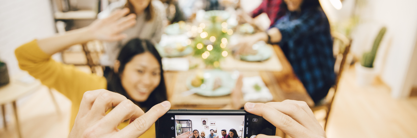 A group of people sitting at a dinner table taking a picture