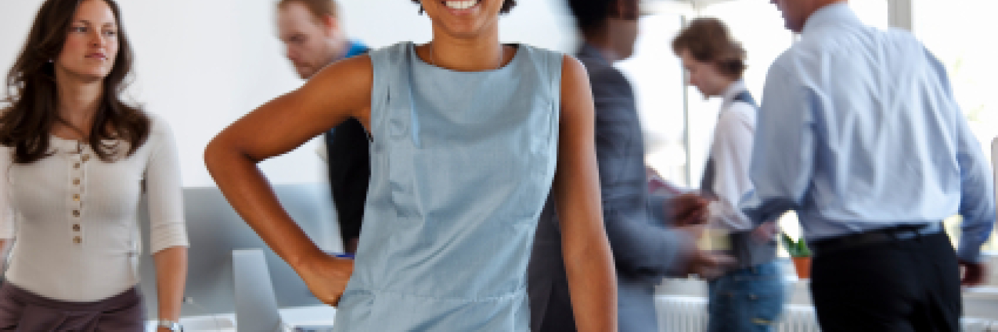 smiling businesswoman in busy office 