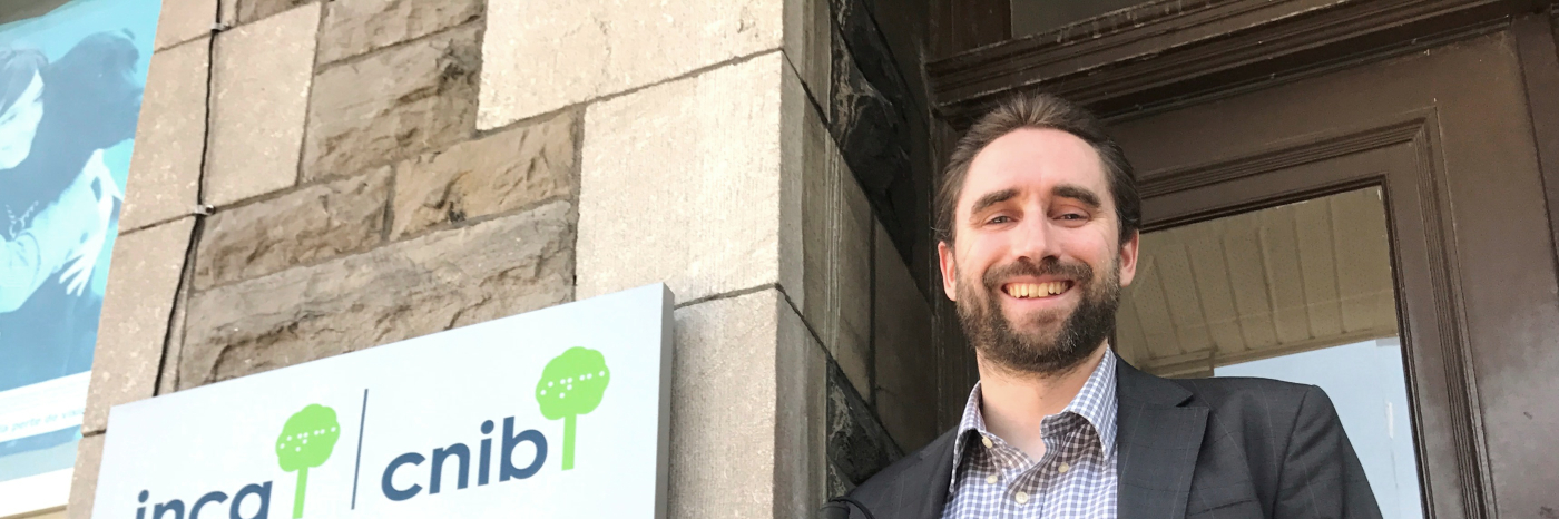 David Demers, cane in hand, stands proudly in front of the CNIB office.