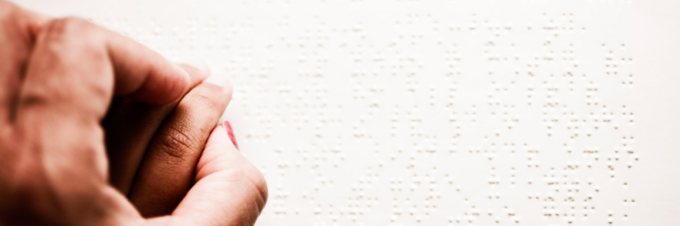 Hands reading braille