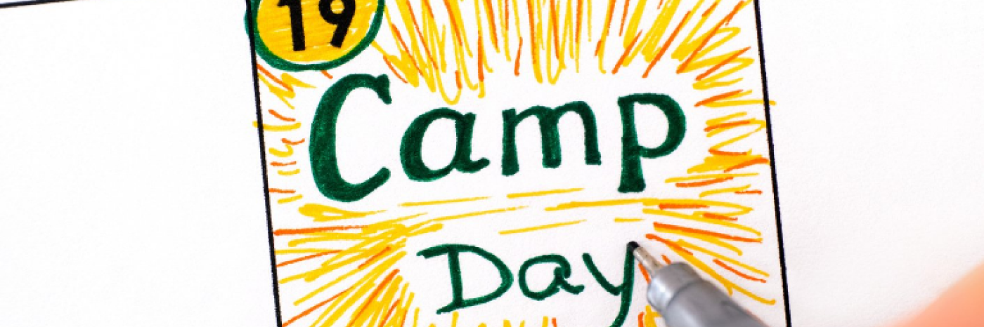 The words "Camp Day" written on a calendar with yellow streaks to make it look like sunshine.