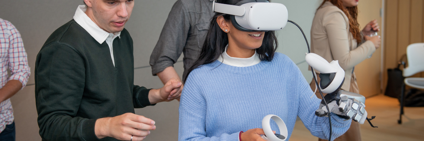 A woman uses a wearable headset and uses virtual reality tech. 