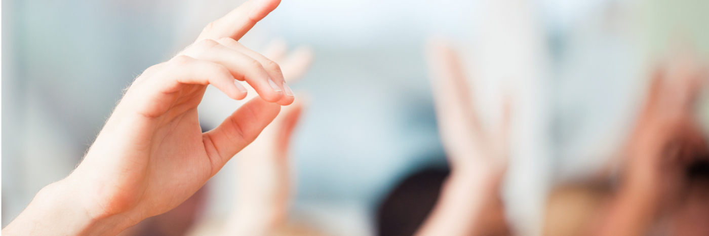 Hands raised to ask questions.