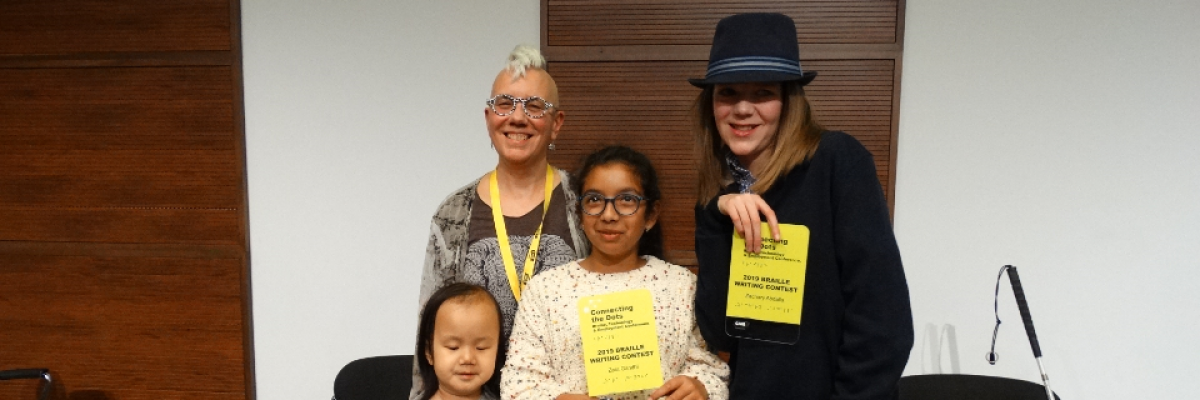 Winners from the 2019 Braille Creative Writing Contest Kelsey, Zara and Zachary pose for a photo with Karen Brophey. They are holding their awards
