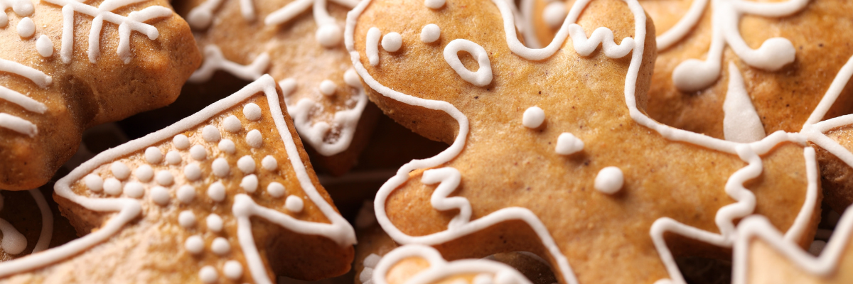 A stack of gingerbread cookies decorated with white frosting.
