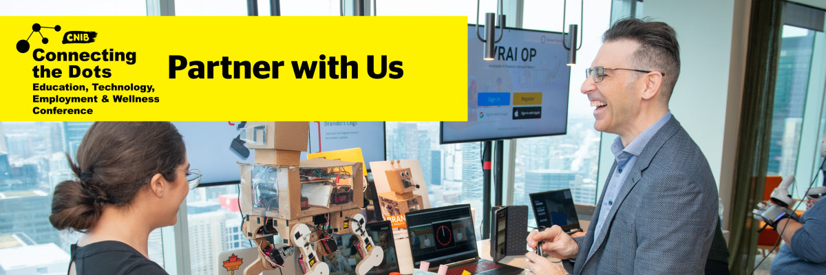 A man in a suit holding a white can speaking to a woman in front of a table full of robotic tech next to the CNIB Connecting the Dots logo and text which reads Partner with Us.
