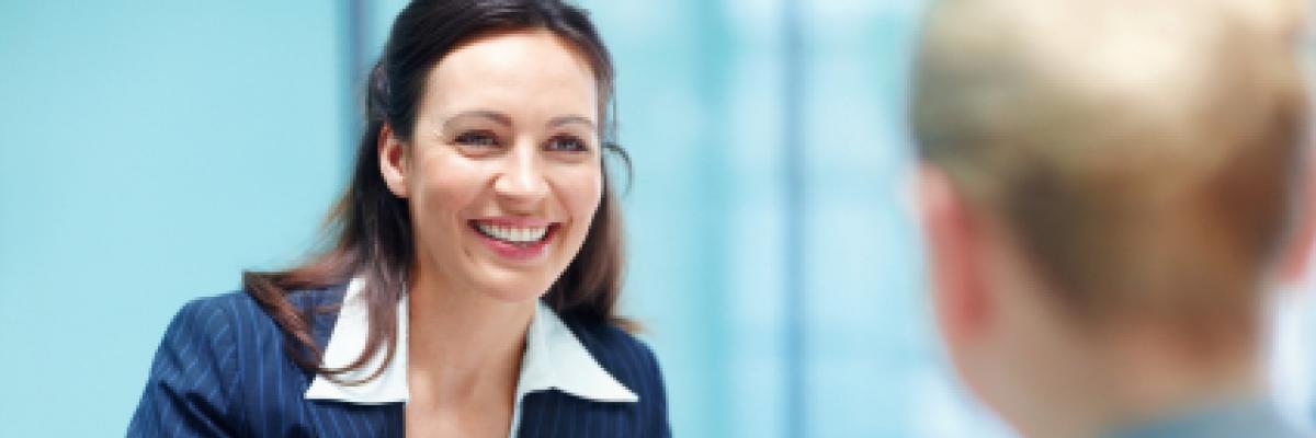 Businesswoman smiling and holding paper