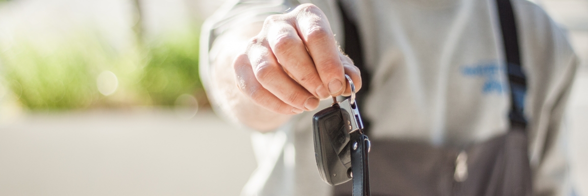 Photo of person holding out car keys
