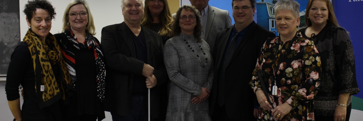 Members of City of St John's, Paradise and Mount Pearl and clients Cindy Antle and George Sweeney pose for a photo