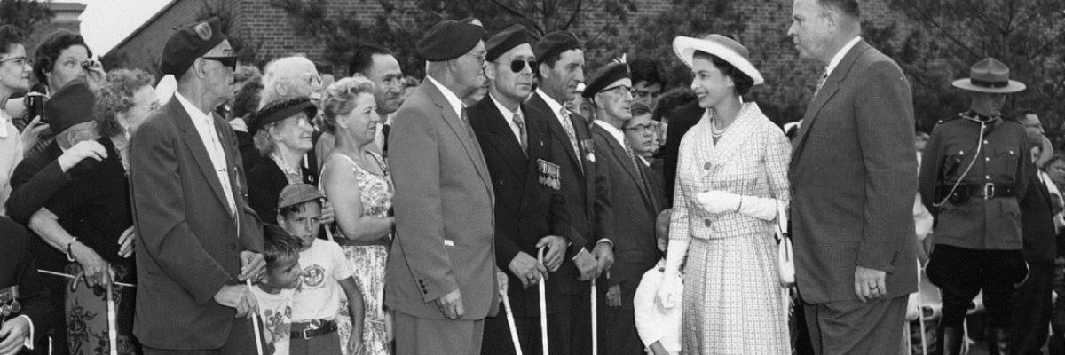 Her Majesty Queen Elizabeth II meets with CNIB’s then-president Ralph Misener and veterans with sight loss in CNIB’s fragrant garden, Toronto, 1959.