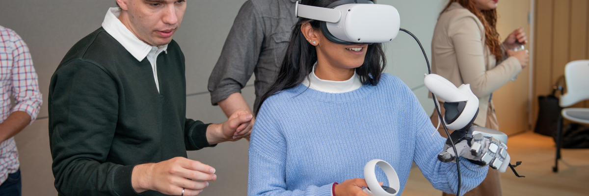 A woman uses a wearable headset and uses virtual reality tech. 