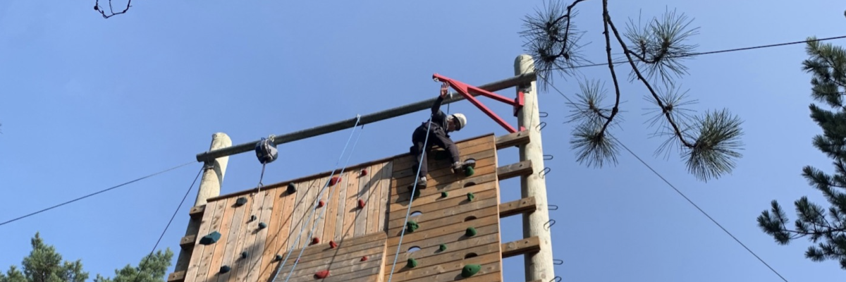 Bev Dean climbing the rock wall at Lake Joe