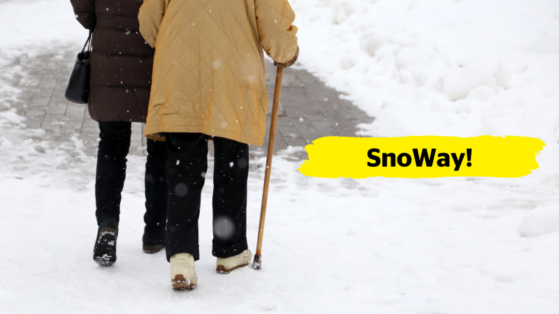 Two people from behind walk down a snowy pathway. One elderly person uses a walking cane and holds onto the elbow of their companion. In the centre of the image, there is a yellow banner overlay with the text “SnoWay!”