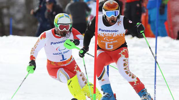 Chris Williamson competing in Sochi 2014, pictured with his guide. Source: CBC.