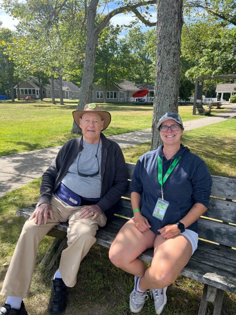 John is enjoying a sunny afternoon outdoors at CNIB Lake Joe with a DBCS intervenor.