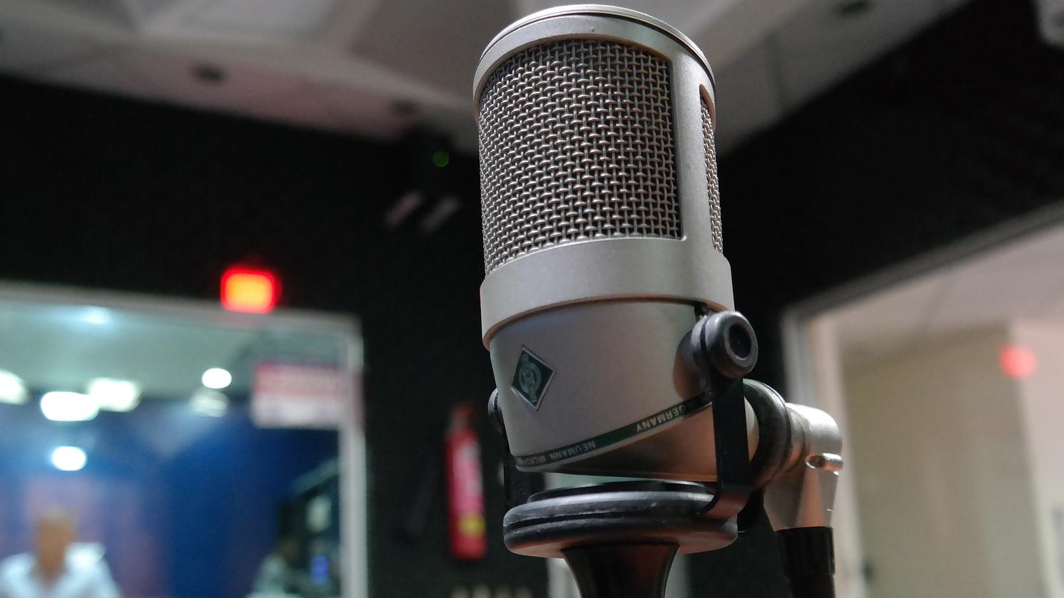 Image of a microphone placed in a recording studio. 