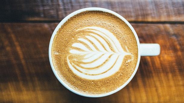 A coffee cup sits on a table. 