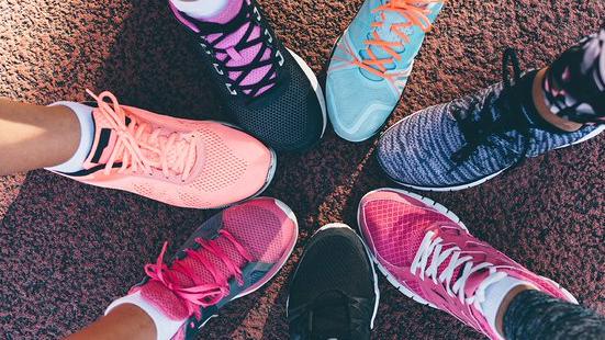 Seven different running shoes come together to form a circle. 
