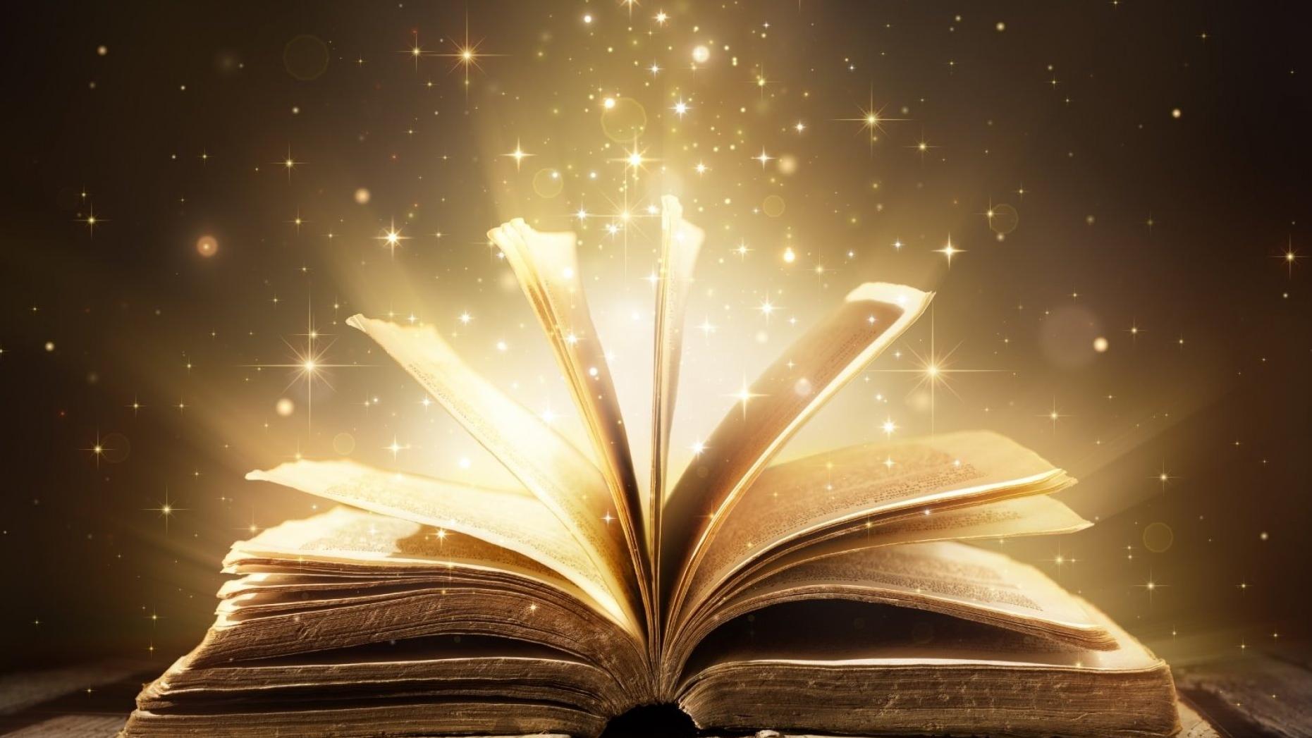 A book cracked opened wide on a table with an illustration of magical stars rising out of the book pages.
