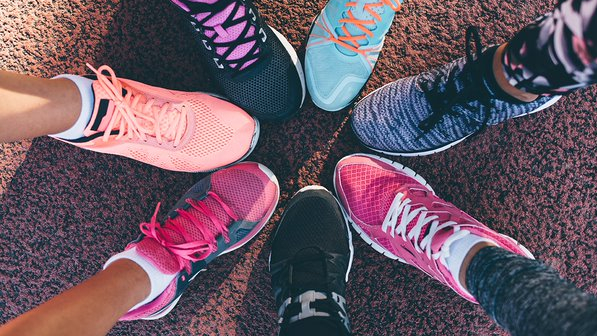 Seven different running shoes come together to form a circle. 