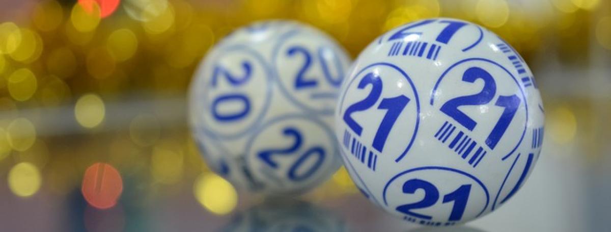 Two  bingo balls imprinted with numbers and letters used in the selection process of a bingo game.