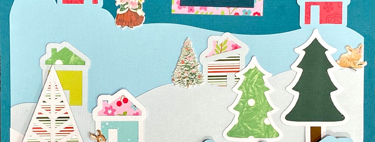 A blue page with colourful cutouts of trees, homes, snowbanks, etc.