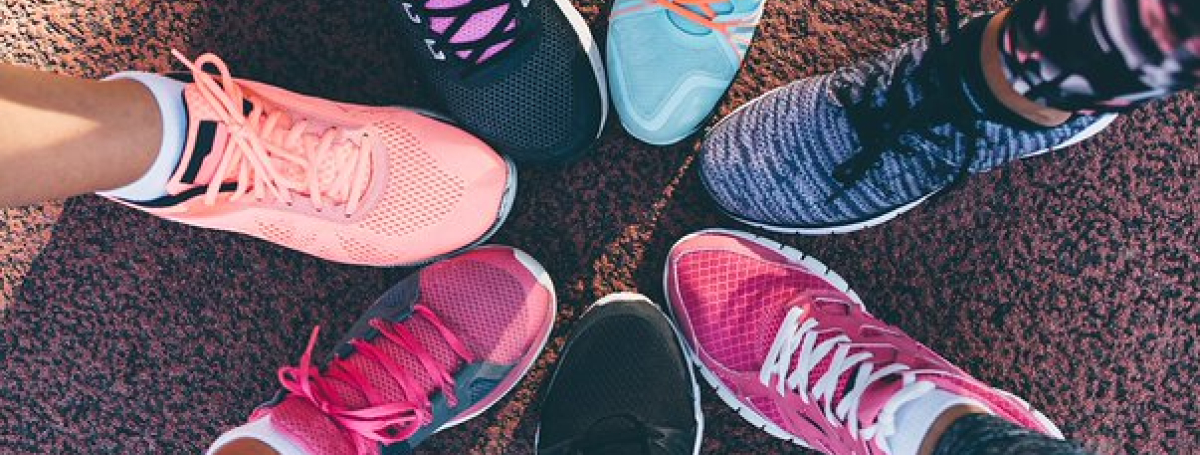 Seven different running shoes come together to form a circle. 