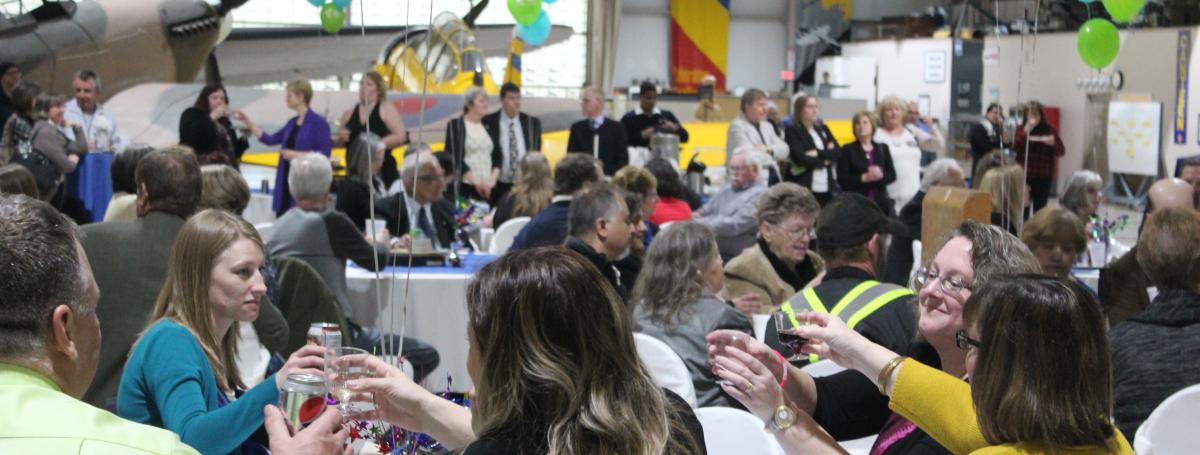 People sitting at tables in a festive setting.