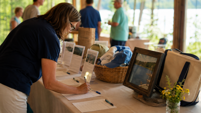 A person placing a bid at a silent auction