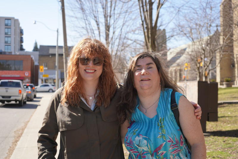 two staff, smiling