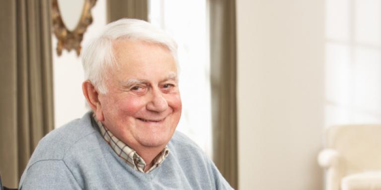 Elderly man smiling into camera