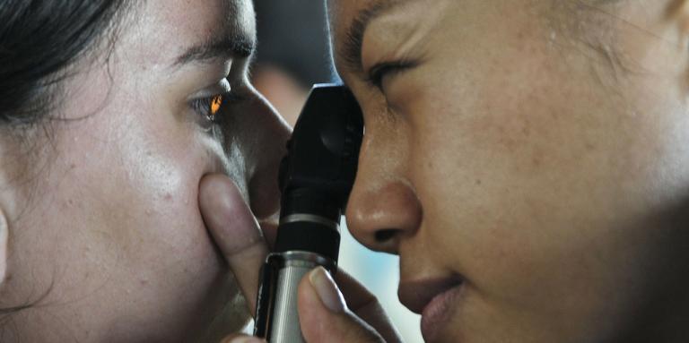 Optometrist checking a child's eye