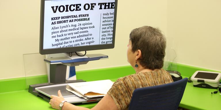 A woman sits at a CCTV.