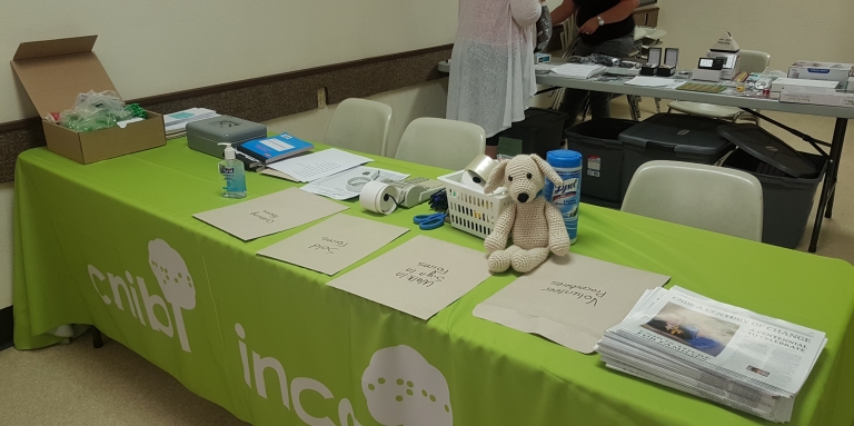 a table with pamphlets, markers, registration forms and swag