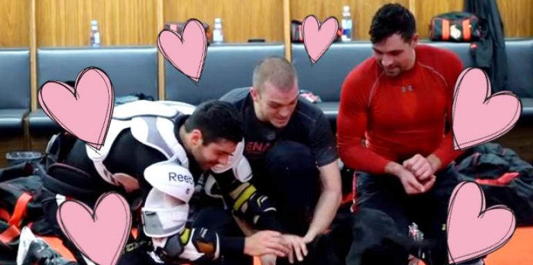 Ottawa Senators players play with puppy in locker room