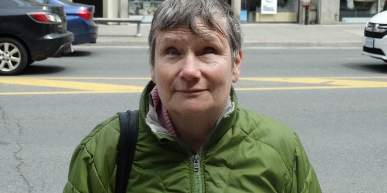 A photo of Debbie Gillespie standing outside the CNIB Toronto Community Hub.