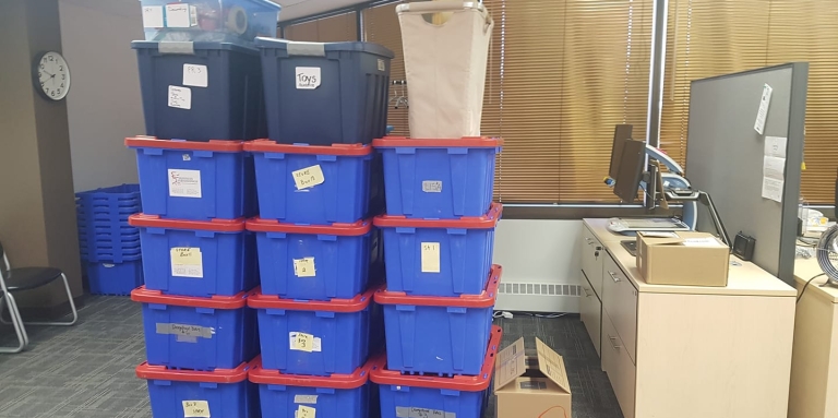 a row of boxes sit on the carpet