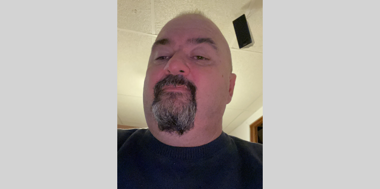 A selfie of Jason. He has a goatee and is wearing a blue shirt.