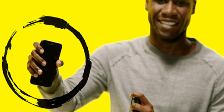 a man holds up a smartphone